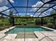 Beautiful screened-in pool with a spa and lush landscaping creates a private oasis at 5832 Semolino St, Nokomis, FL 34275