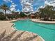 Beautiful outdoor pool with ample lounge chairs and umbrellas, perfect for relaxation under the sun at 5832 Semolino St, Nokomis, FL 34275