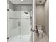 Beautiful shower with glass door, rainfall showerhead, bench, and white tile and mosaic accent at 5832 Semolino St, Nokomis, FL 34275