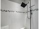 Modern shower with rainfall showerhead, bench, and white tile and mosaic accent at 5832 Semolino St, Nokomis, FL 34275