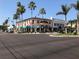 Charming Sarasota trolley makes its way past shops with colorful awnings and flower boxes at 5832 Semolino St, Nokomis, FL 34275
