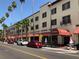 View of San Marco street and the shops under red awnings lined with palm trees at 5832 Semolino St, Nokomis, FL 34275