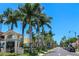Charming street view of Venice, Florida, with palm trees and local signage on a clear sky day at 5832 Semolino St, Nokomis, FL 34275
