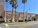 Exterior view of Venice Theater with its peach stucco walls and tall palm trees at 5832 Semolino St, Nokomis, FL 34275