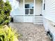 Spacious brick patio with a white wooden railing, perfect for outdoor entertaining and relaxation at 660 N Green Cir, Venice, FL 34285