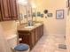 A full bathroom showcases a dual sink vanity and plenty of cabinet storage for your convenience at 660 N Green Cir, Venice, FL 34285