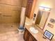 The bathroom features a walk-in shower with grab bars for accessibility and safety at 660 N Green Cir, Venice, FL 34285