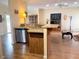 An open concept kitchen boasts stainless steel appliances and a breakfast bar for additional seating at 660 N Green Cir, Venice, FL 34285