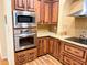 Modern kitchen with stainless steel appliances, custom cabinets, and ample counter space at 660 N Green Cir, Venice, FL 34285