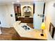 Well-equipped kitchen with a double sink, custom cabinetry, and stainless steel appliances and view to the living room at 660 N Green Cir, Venice, FL 34285