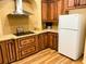 Modern kitchen features stainless steel appliances, a tile backsplash, and custom wood cabinetry at 660 N Green Cir, Venice, FL 34285