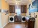 This laundry room is equipped with a washer, dryer and cabinetry with countertop at 660 N Green Cir, Venice, FL 34285