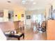 Open-concept living room featuring hardwood floors, a ceiling fan, and lots of natural light at 660 N Green Cir, Venice, FL 34285