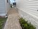 This walkway features brick pavers and provides access around the home at 660 N Green Cir, Venice, FL 34285