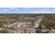 Wide aerial view of the community showcasing lush landscaping, ponds, residential buildings, and tennis courts at 6800 Placida Rd # 280, Englewood, FL 34224