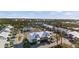 Stunning aerial view of a coastal community featuring white buildings, lush landscaping, and a community pool and tennis courts at 6800 Placida Rd # 280, Englewood, FL 34224