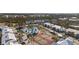 Aerial view of the community with a pool, tennis courts, lush landscaping, and charming residential buildings at 6800 Placida Rd # 280, Englewood, FL 34224
