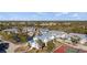Scenic community featuring multiple buildings, a pond, tennis court, parking, and lush landscaping at 6800 Placida Rd # 280, Englewood, FL 34224