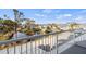 Scenic community view from the balcony showcasing lush landscaping, a tranquil pond, and charming residential buildings at 6800 Placida Rd # 280, Englewood, FL 34224