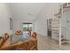 Bright dining room with a glass-top table, modern fan, and spiral staircase at 6800 Placida Rd # 280, Englewood, FL 34224