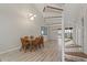 Bright dining room with a wooden table, modern light fixture, and spiral staircase at 6800 Placida Rd # 280, Englewood, FL 34224
