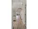 Hallway featuring a unique spiral staircase and plank flooring with views of an outdoor patio at 6800 Placida Rd # 280, Englewood, FL 34224