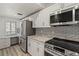 Kitchen featuring stainless steel appliances, granite countertops, ample white cabinetry, and a window view at 6800 Placida Rd # 280, Englewood, FL 34224