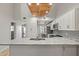 Bright and spacious kitchen featuring white cabinetry, stainless steel appliances, granite countertops, and a breakfast bar at 6800 Placida Rd # 280, Englewood, FL 34224