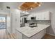 Bright and spacious kitchen featuring white cabinetry, stainless steel appliances, and granite countertops at 6800 Placida Rd # 280, Englewood, FL 34224