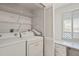 Convenient laundry room with a washer, dryer, wire shelving, a window, and a countertop with drawers at 6800 Placida Rd # 280, Englewood, FL 34224