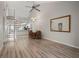 Open living room with a wooden table, modern light fixture, and spiral staircase at 6800 Placida Rd # 280, Englewood, FL 34224
