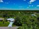 Lawn shot from an elevated angle with a blue sky and scattered clouds at 6964 Glacier Ave, North Port, FL 34291