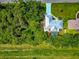 Aerial shot of the home, green lawn and blue tinted driveway at 6964 Glacier Ave, North Port, FL 34291