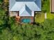 Aerial view showcases the home's metal roof and screened-in pool area at 6964 Glacier Ave, North Port, FL 34291