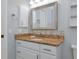 Bathroom vanity featuring granite countertop, tile backsplash and brushed metal fixtures at 6964 Glacier Ave, North Port, FL 34291