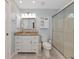 Bright bathroom featuring a glass shower, granite counters, and ample cabinet space at 6964 Glacier Ave, North Port, FL 34291