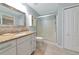 Beautiful bathroom featuring granite countertops, a glass enclosed shower, and ample cabinetry at 6964 Glacier Ave, North Port, FL 34291