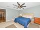 Bright bedroom featuring a unique headboard, light-colored walls, and wood-look floors at 6964 Glacier Ave, North Port, FL 34291