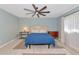 This bedroom offers a soothing blue palette, complemented by wood-look floors and warm lighting at 6964 Glacier Ave, North Port, FL 34291