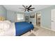 Comfortable bedroom featuring wood-look flooring, a ceiling fan, and an ensuite bathroom at 6964 Glacier Ave, North Port, FL 34291