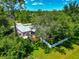 Elevated shot of the yard and property featuring a white fence and lush green grass at 6964 Glacier Ave, North Port, FL 34291