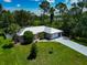 Aerial view highlighting the home with a well-maintained front yard and blue driveway at 6964 Glacier Ave, North Port, FL 34291