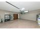 Spacious garage featuring epoxy flooring, built-in storage cabinets, and ample room for vehicles at 6964 Glacier Ave, North Port, FL 34291