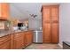 A bright kitchen features granite countertops, stainless appliances, and wood flooring at 6964 Glacier Ave, North Port, FL 34291