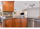 Updated kitchen boasts stainless steel appliances, granite countertops, wood cabinets and open view into the living room at 6964 Glacier Ave, North Port, FL 34291