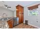 The kitchen features stainless steel appliances, granite countertops, and a convenient tall cabinet at 6964 Glacier Ave, North Port, FL 34291