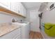 Laundry room featuring upper cabinets, granite countertop, washer and dryer at 6964 Glacier Ave, North Port, FL 34291