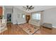 Bright living room with a vaulted ceiling features stylish furnishings, hardwood floors, and large windows with great natural light at 6964 Glacier Ave, North Port, FL 34291