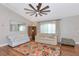 Bright living room with a vaulted ceiling features stylish furnishings, hardwood floors, and large windows with great natural light at 6964 Glacier Ave, North Port, FL 34291