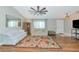 Bright living room with a vaulted ceiling features stylish furnishings, hardwood floors, and large windows with great natural light at 6964 Glacier Ave, North Port, FL 34291